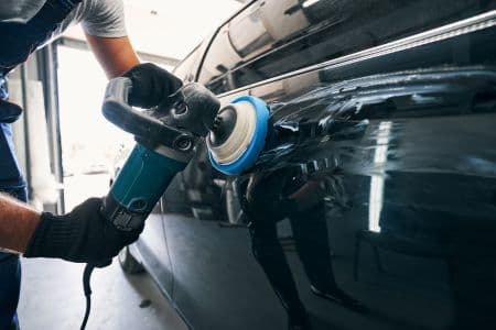 Technician polishing a vehicle panel (placeholder image)
