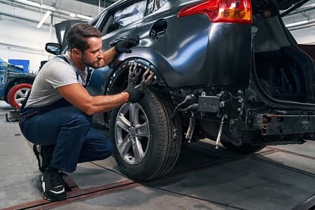 Technician working on a vehicle wheel arch (placeholder image)